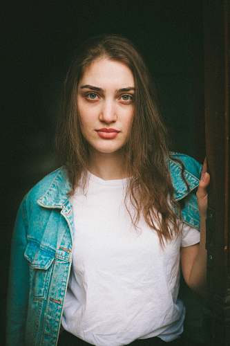 person woman in blue denim jacket holding door human