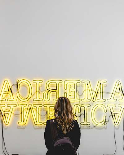 person woman in front American lighted signage human