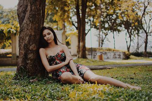 person woman leaning on tree during daytime human