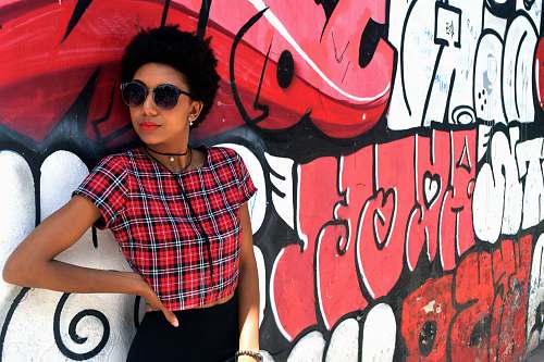 human woman leaning on wall while looking sideward graffiti
