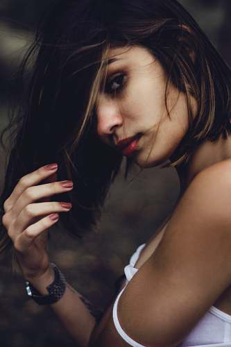person woman raising left arm wearing white shirt human