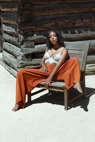 human woman sitting on brown wooden armchair outdoor woman