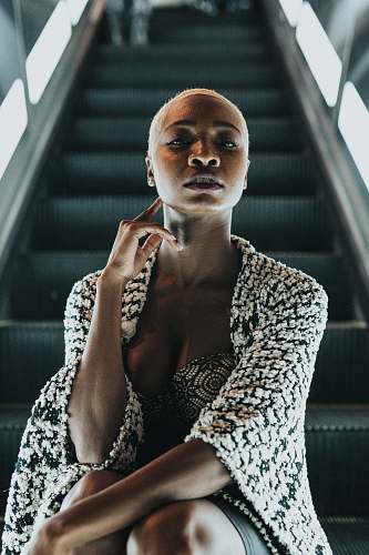 person woman sitting on escalator human