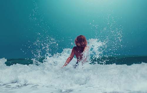 human woman sitting on seashore person