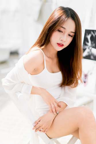 human woman sitting on white metal stair railing during daytime person