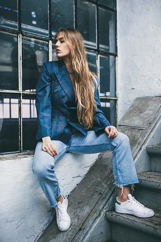human woman sitting on window near staircase person