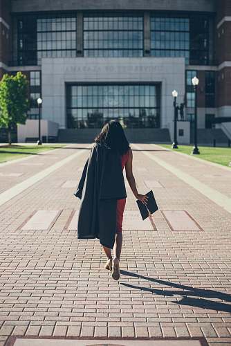 person woman standing at facade of Alabama University building human