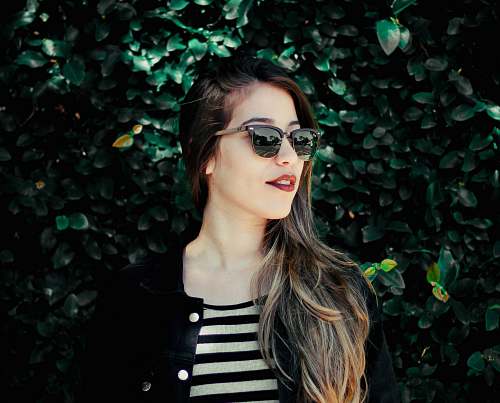 person woman standing beside the hedge human