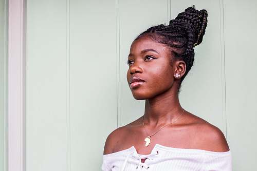 person woman standing beside white wall human