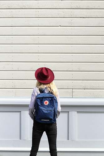 person woman standing in front of wooden wall human