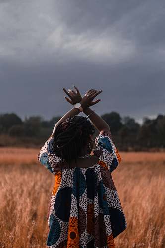 person woman standing in the middle of wheat field woman
