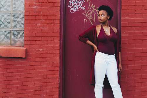 person woman standing near wall brick