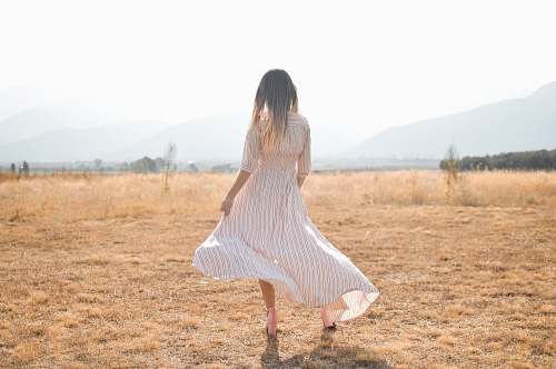 person woman standing on plain brown field human