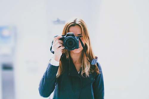 person woman taking photo using DSLR camera human