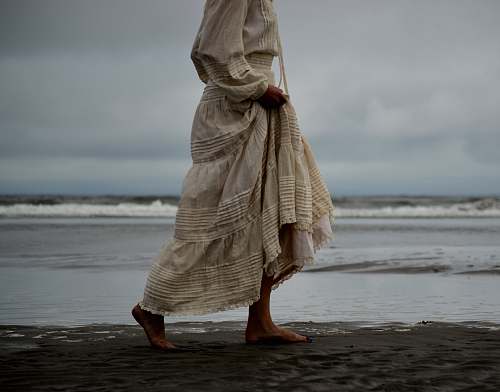 person woman walking on seashore human