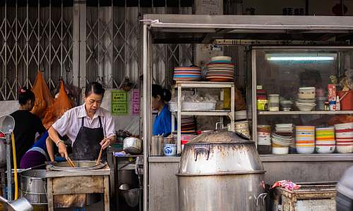 person woman wearing black apron while cooking human