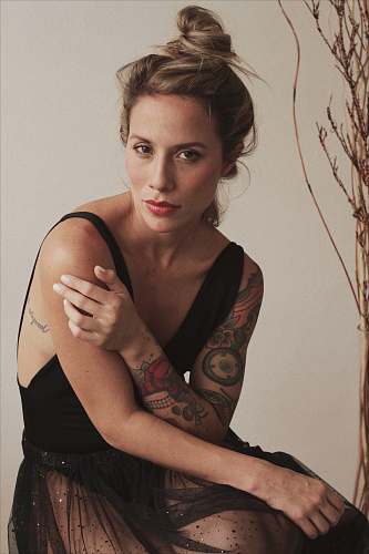 person woman wearing black sleeveless dress human