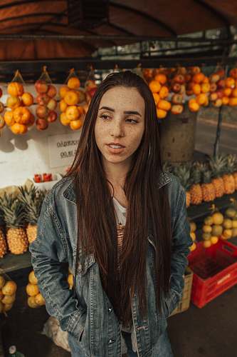 person woman wearing blue jacket in fruit store human