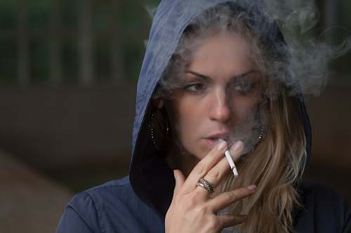 person woman wearing hoodie while holding cigarette human