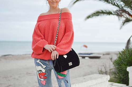 vase woman wearing long-sleeved top and black sling bag pottery