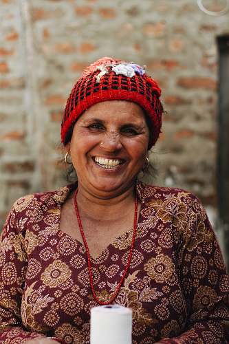 human woman wearing red and black knit cap person