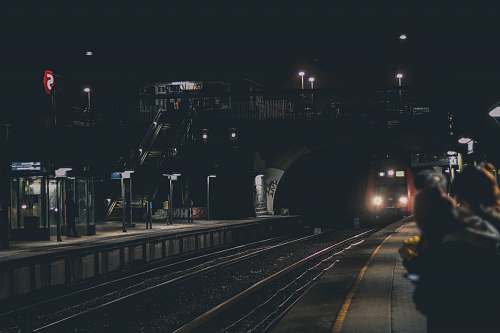 people black train under foot bridge human