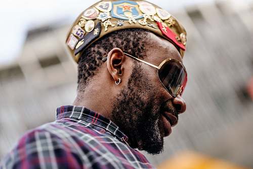 people close-up photography of smiling man wearing sunglasses human