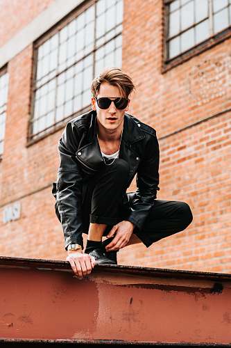 people man sitting on red roof human