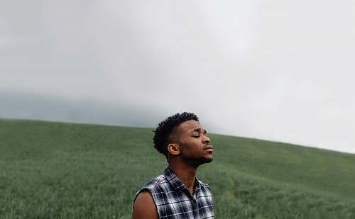people man wearing black, gray, and white plaid sleeveless top human