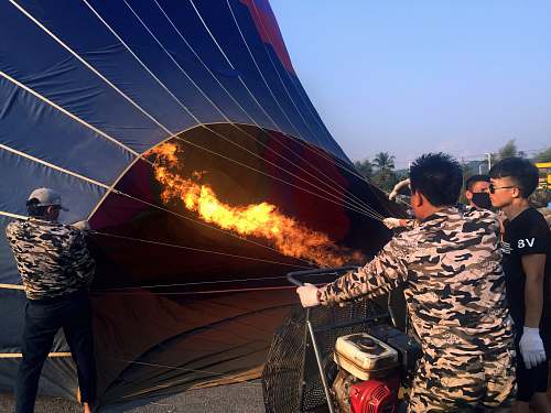 people people blowing fire on hot air ballooon human