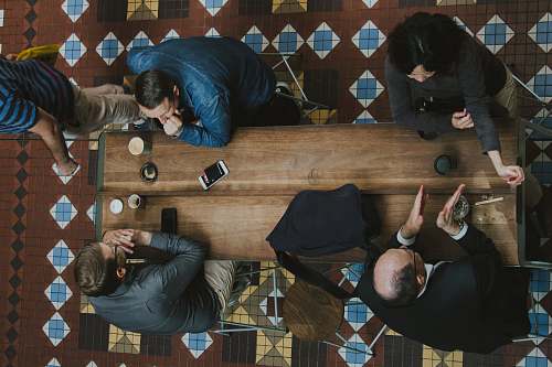 people people sitting near brown wooden coffee table human