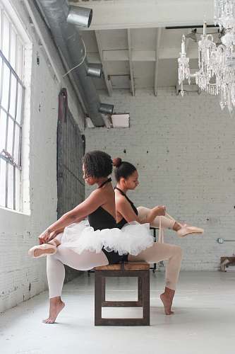 people photo of two ballerina tying their shoes human