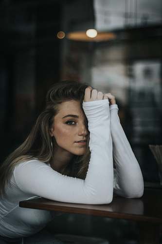 human selective focus photography of woman resting hands on table people
