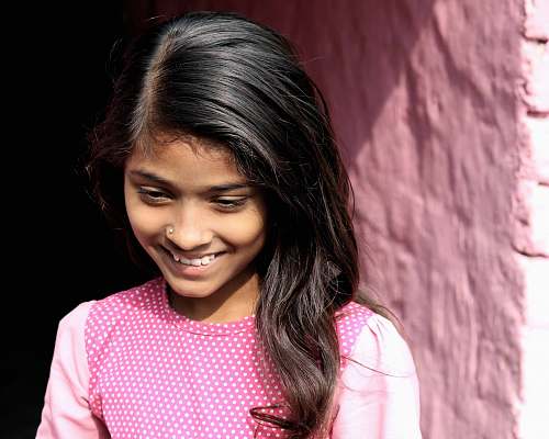 people smiling girl standing near wall girl