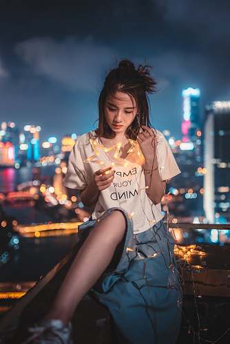 people woman holding star-themed string lights human