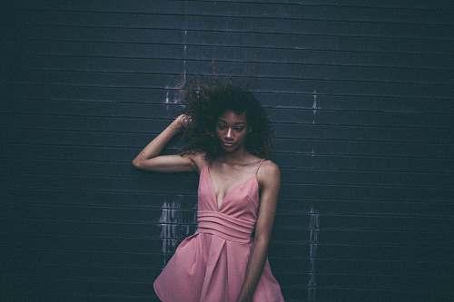 people woman in dress leaning on black wall human