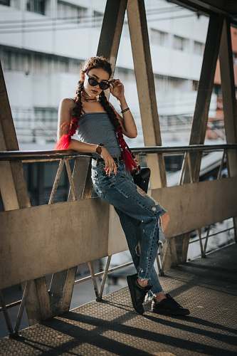 human woman leaning on brown metal frame at daytime people