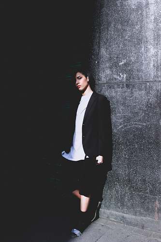 human woman leaning on wall people