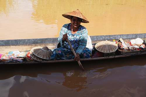 people woman rowing boat on body of water boat