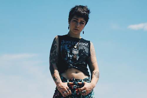 people woman standing wearing crop top under blue sky human
