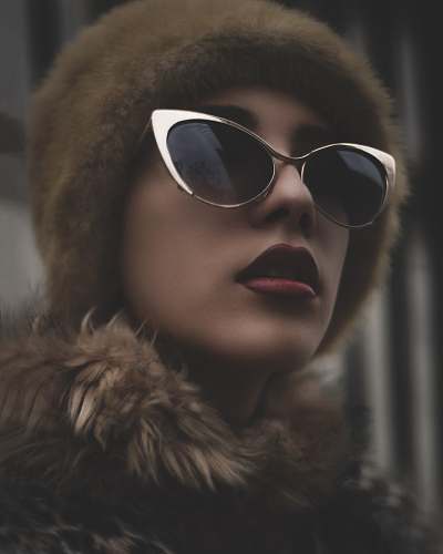 people woman wearing black sunglasses with gold-colored frames human