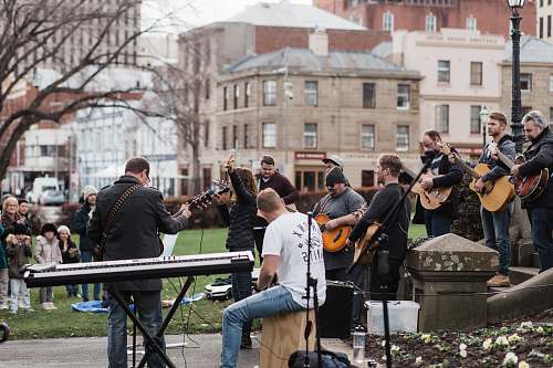 clothing man in blue long sleeve shirt playing electric guitar footwear