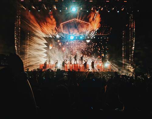 fireworks group of people on stage inside the building outdoors