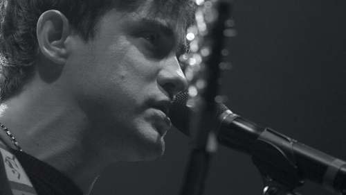 grey gray-scale photo of man using microphone human