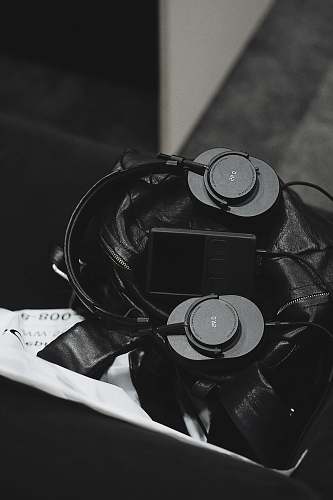 grey grayscale photo of headset and music player electronics