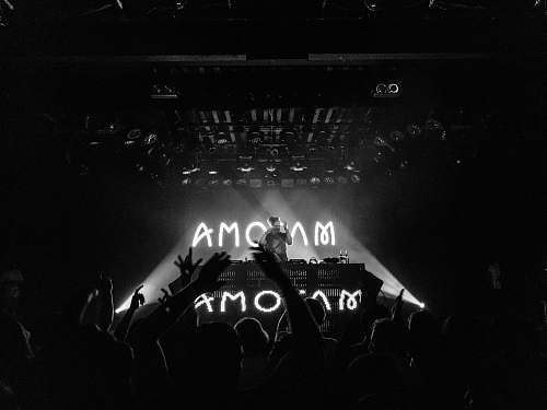 stage grayscale photography of people on party commodore ballroom