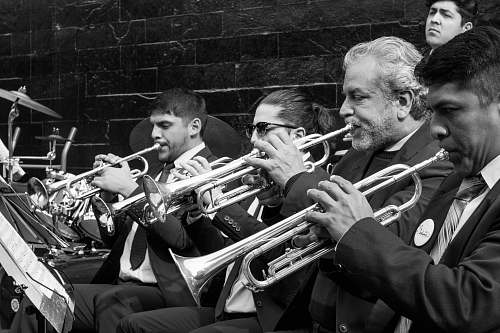 trumpet greyscale photo of trumpet players playing cornet