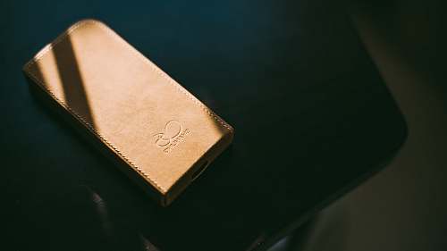 music gold leather wallet on tabletop speaker