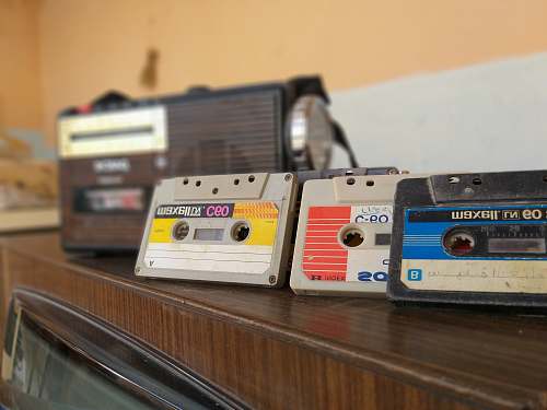 vintage cassette tapes on brown wooden surface radio