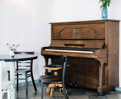 furniture brown piano in front of white wall table